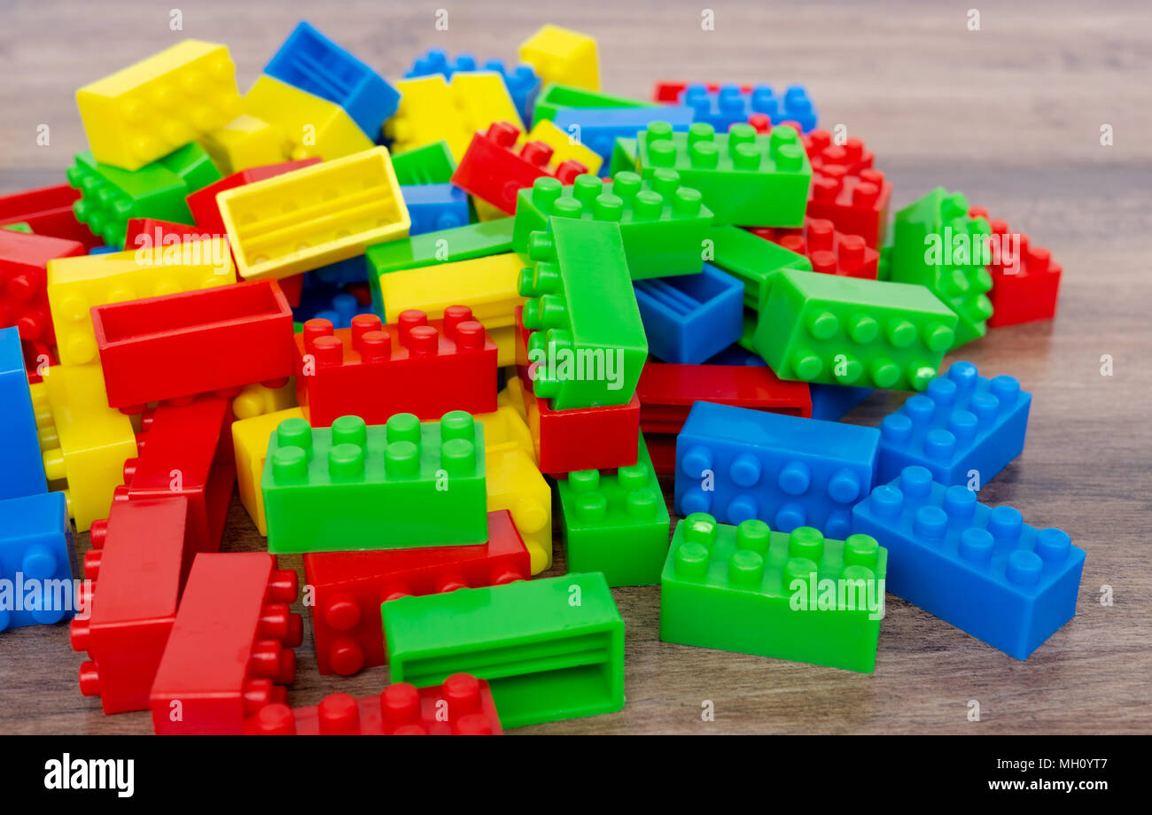 Colorful toy building blocks on wood background. Stock Photo