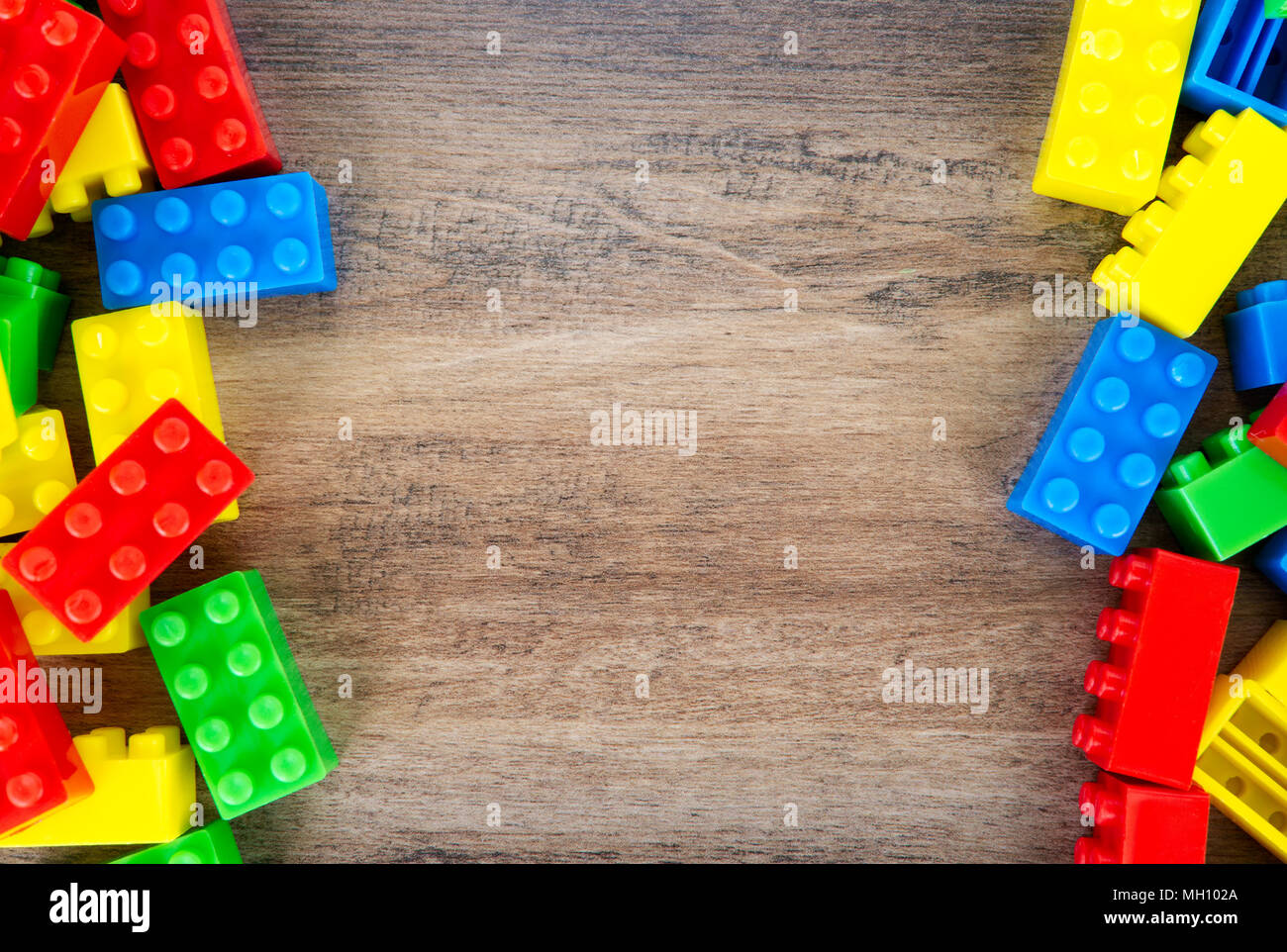 Colorful toy building blocks on wood background. Stock Photo