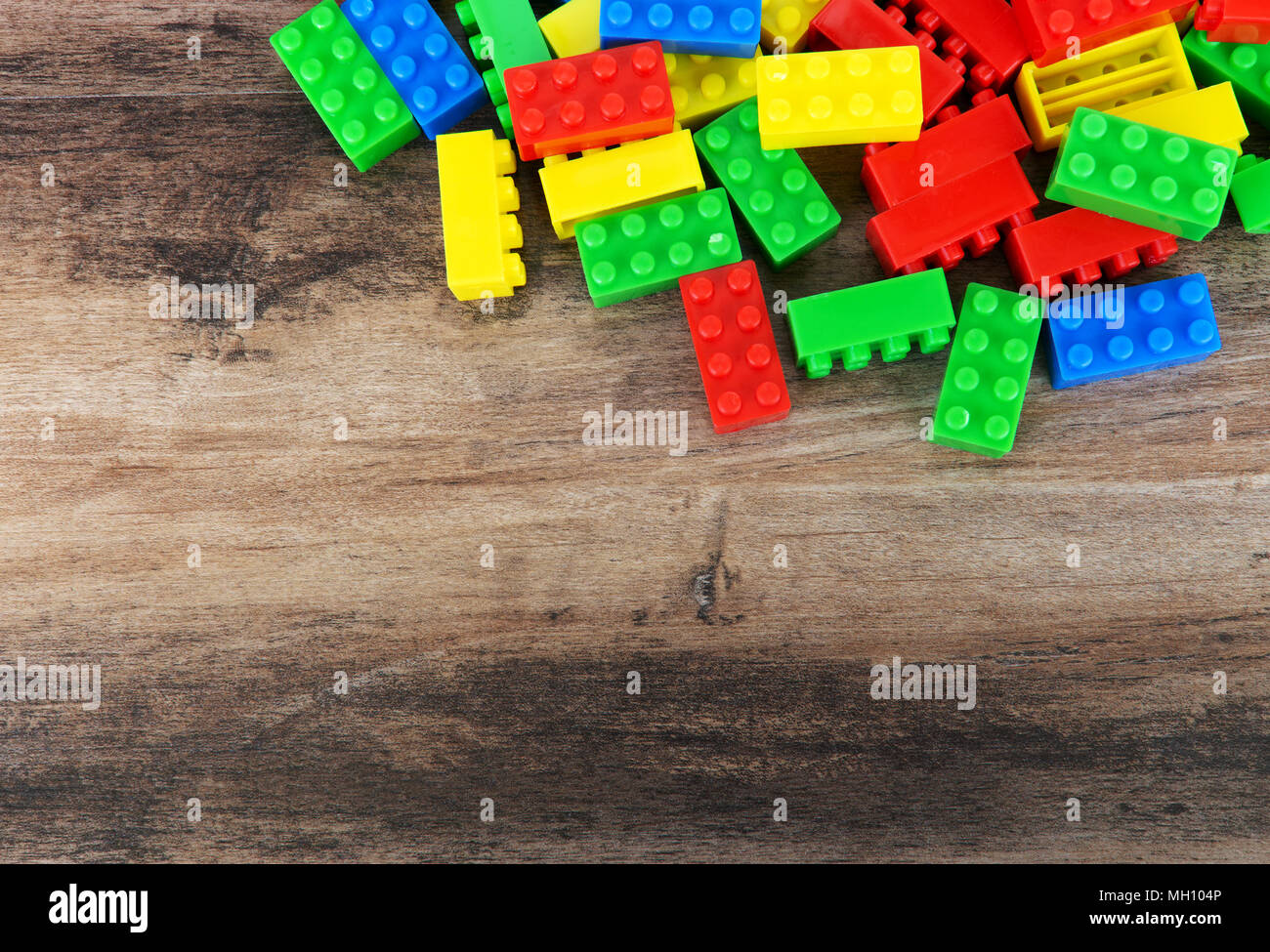 Colorful toy building blocks on wood background with copy space Stock Photo