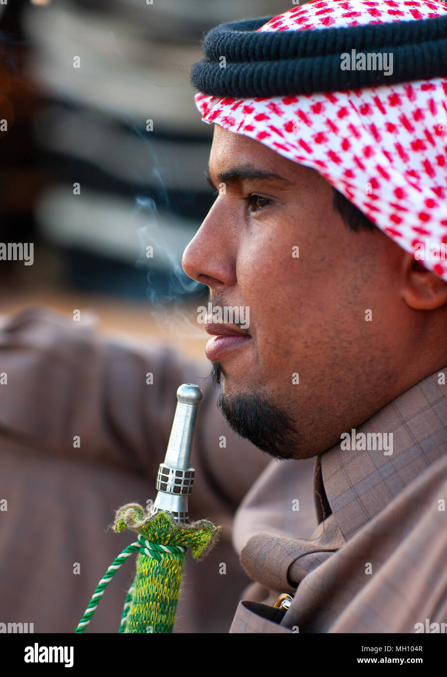 arabian cigarette Saudi bedouin smoking shisha, Al-Jawf Province, Sakaka, Saudi Arabia Stock  Photo