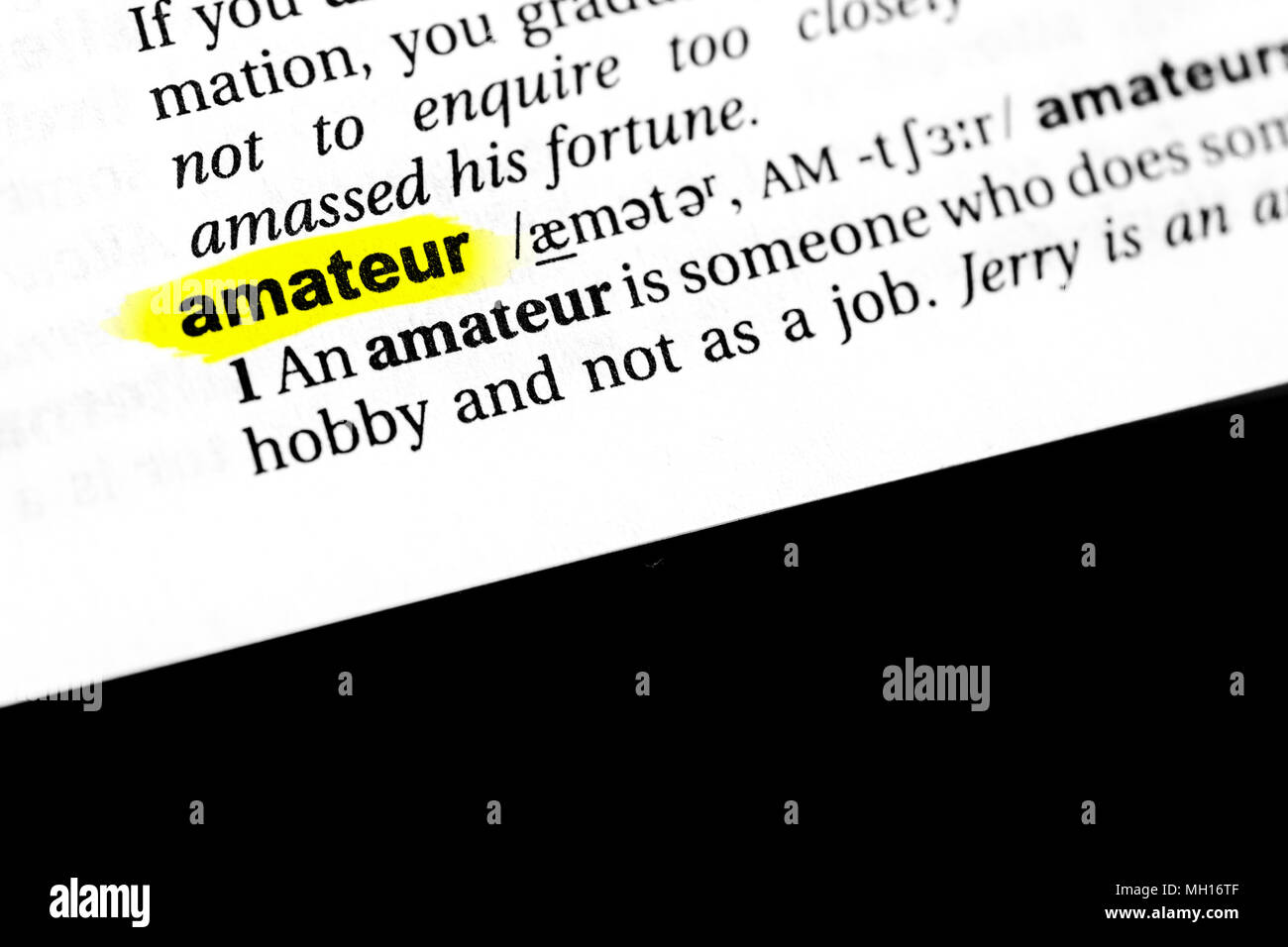 Highlighted English word 'amateur' and its definition in the dictionary. Stock Photo