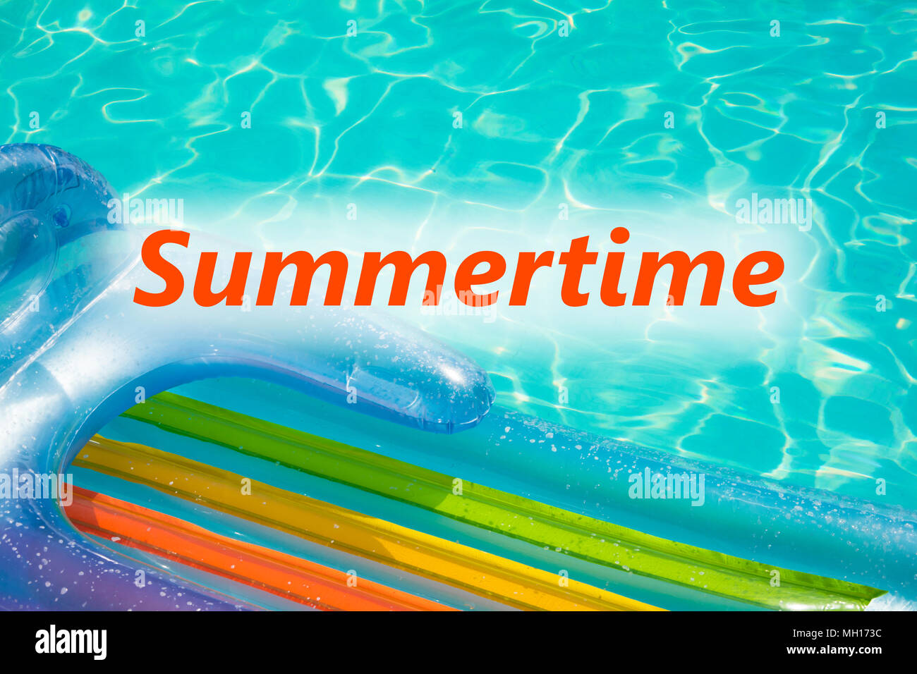 Closeup of air mattress at swimming pool with word Summertime. Stock Photo