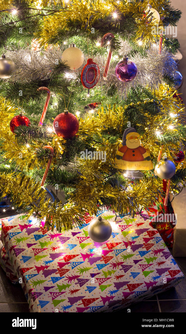 Christmas presents under an artificial Christmas tree Stock Photo