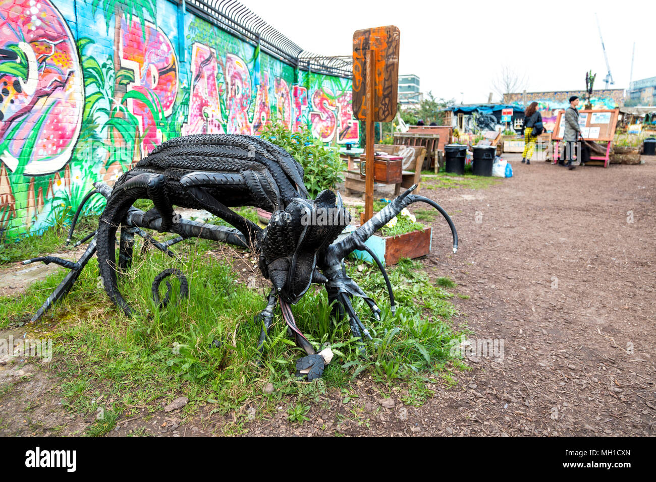 A chameleon sculpture make out of tires by artist Annalisa Mandia at The Nomadic Community Garden off Brick Lane, London, UK Stock Photo