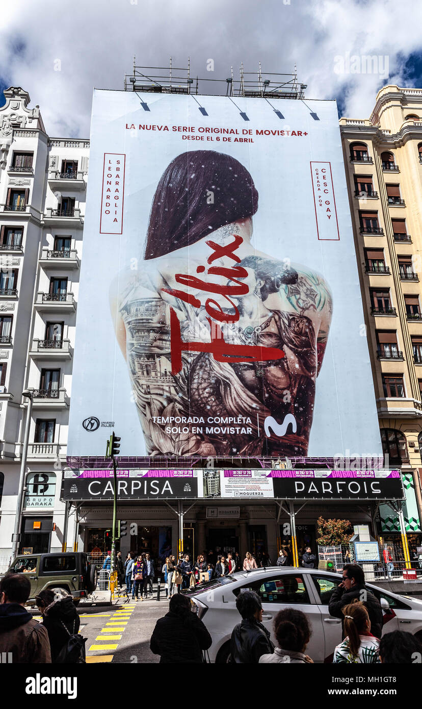 A giant vertical billboard covering building scaffolding, Gran Via, Madrid, Spain. Stock Photo
