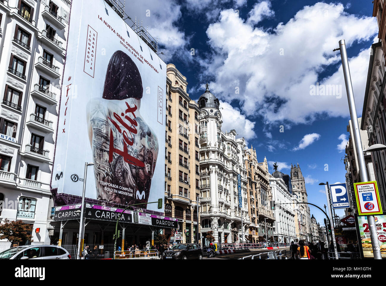 Giant billboard covering the scaffolding on a building front, Gran Via, Madrid, Spain. Stock Photo