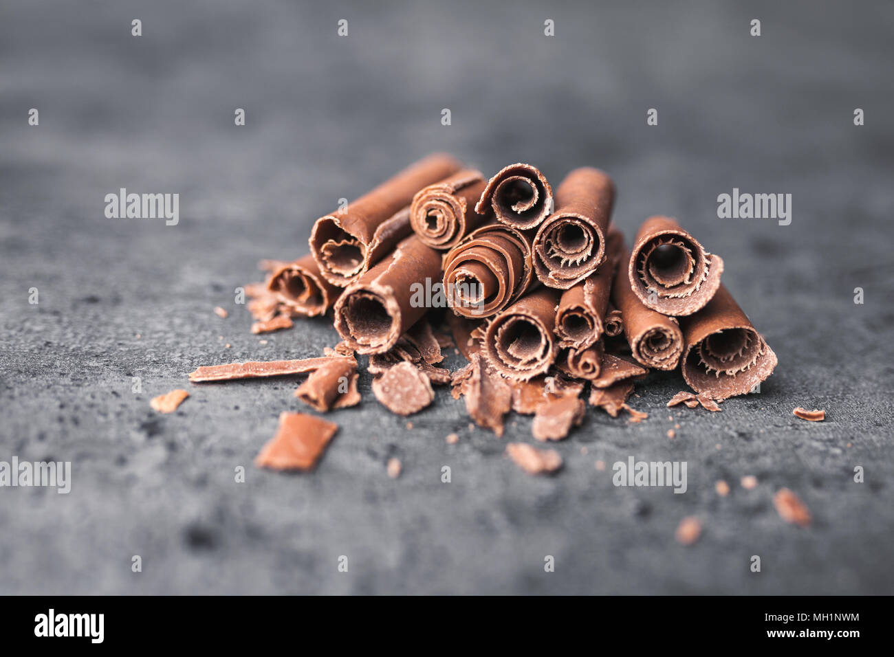 Delicious milk chocolate swilrs on rustic background Stock Photo