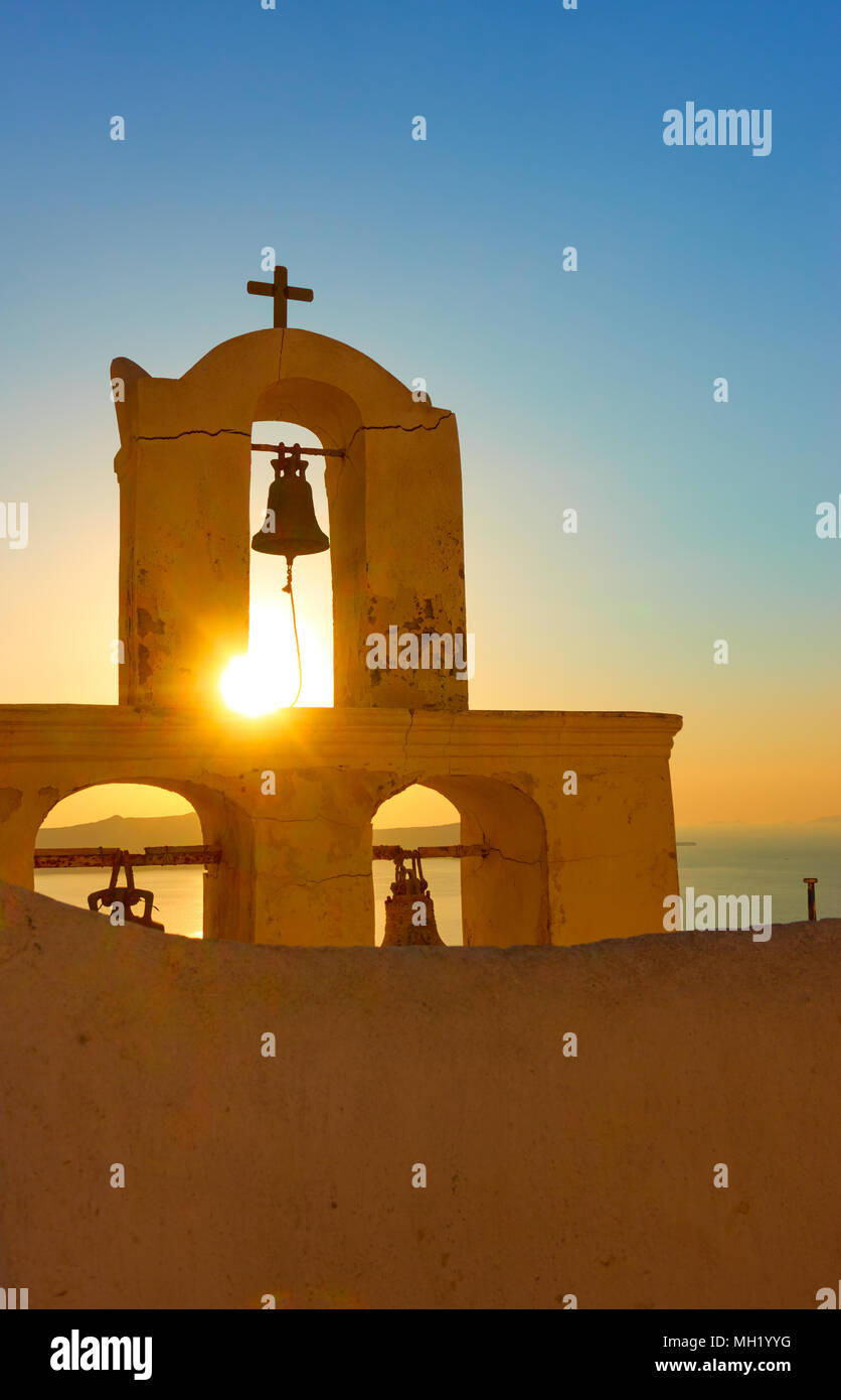 The belfry of a Greek orthodox church in Thira town in Santorini Island at sundown, Greece Stock Photo