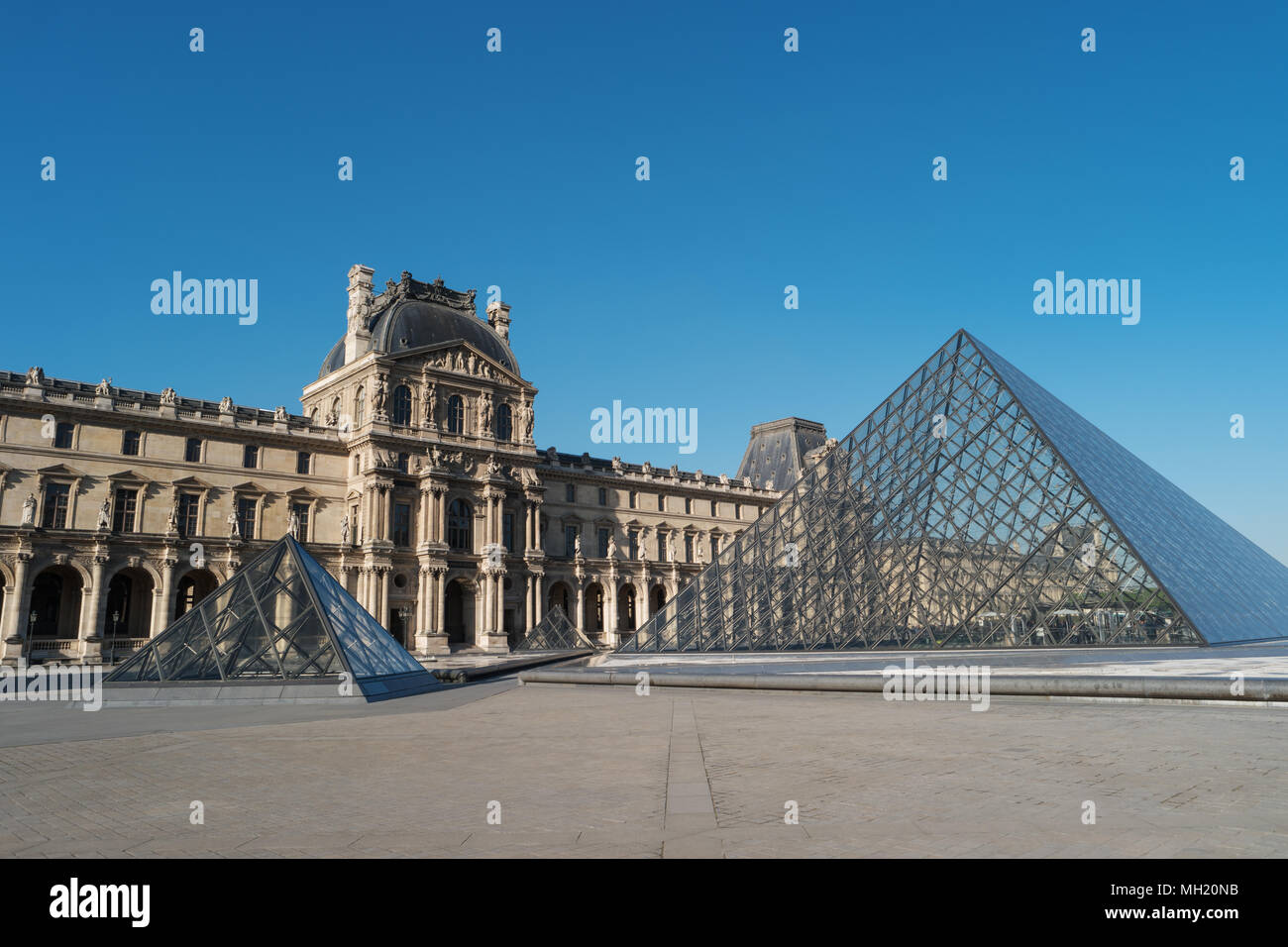 Paris, France, April 27, 2017: Louvre Museum, building and pyramid, France, Europe. Louvre Museum is one of largest and most visited museums worldwide Stock Photo