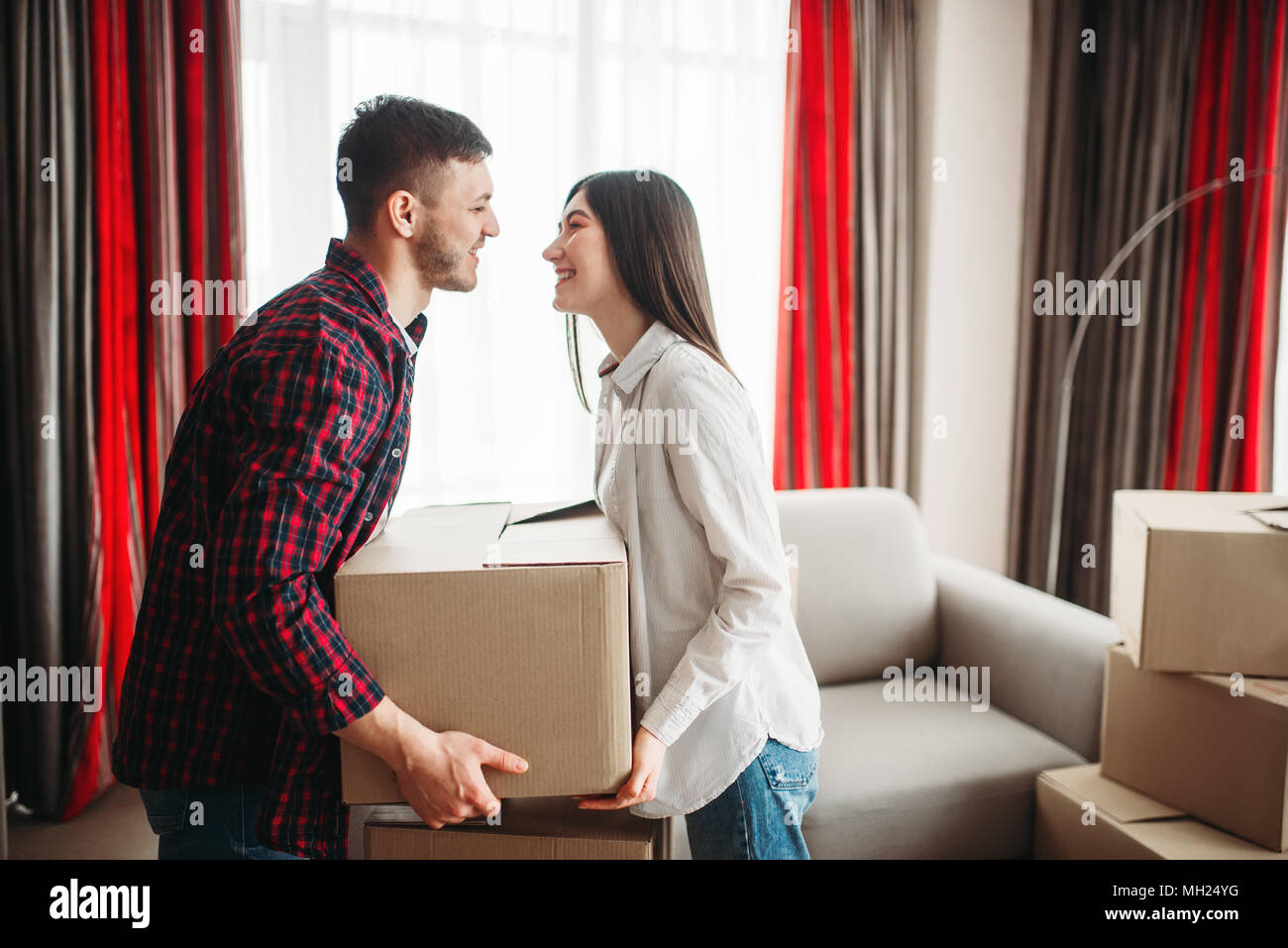 Couple arrange boxes, moving to new house Stock Photo