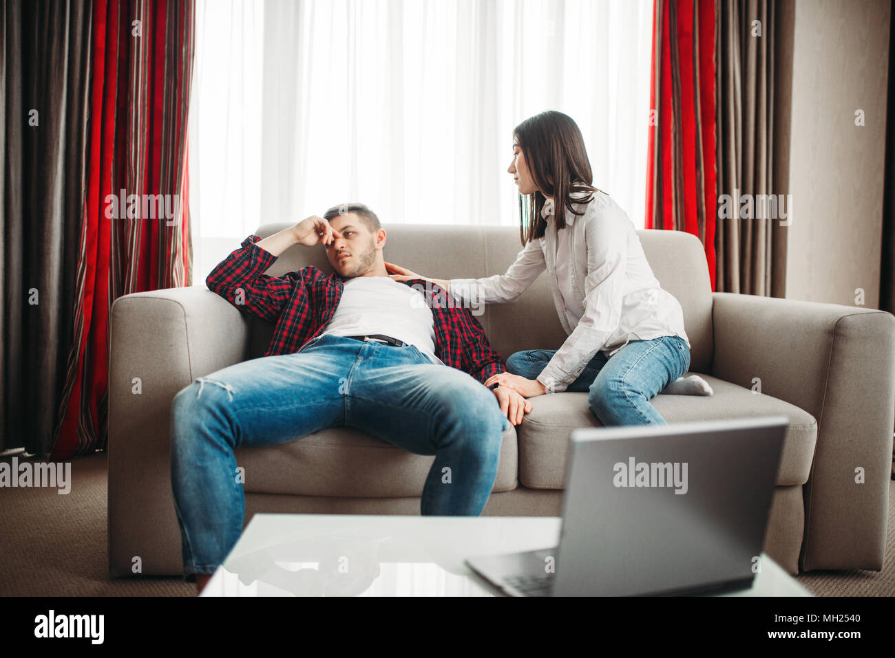 Wife reassures her husband after family quarrel Stock Photo
