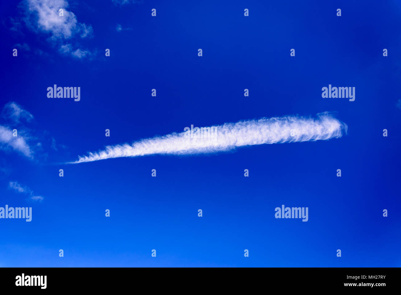 A cloud formation in the shape of a feather Stock Photo