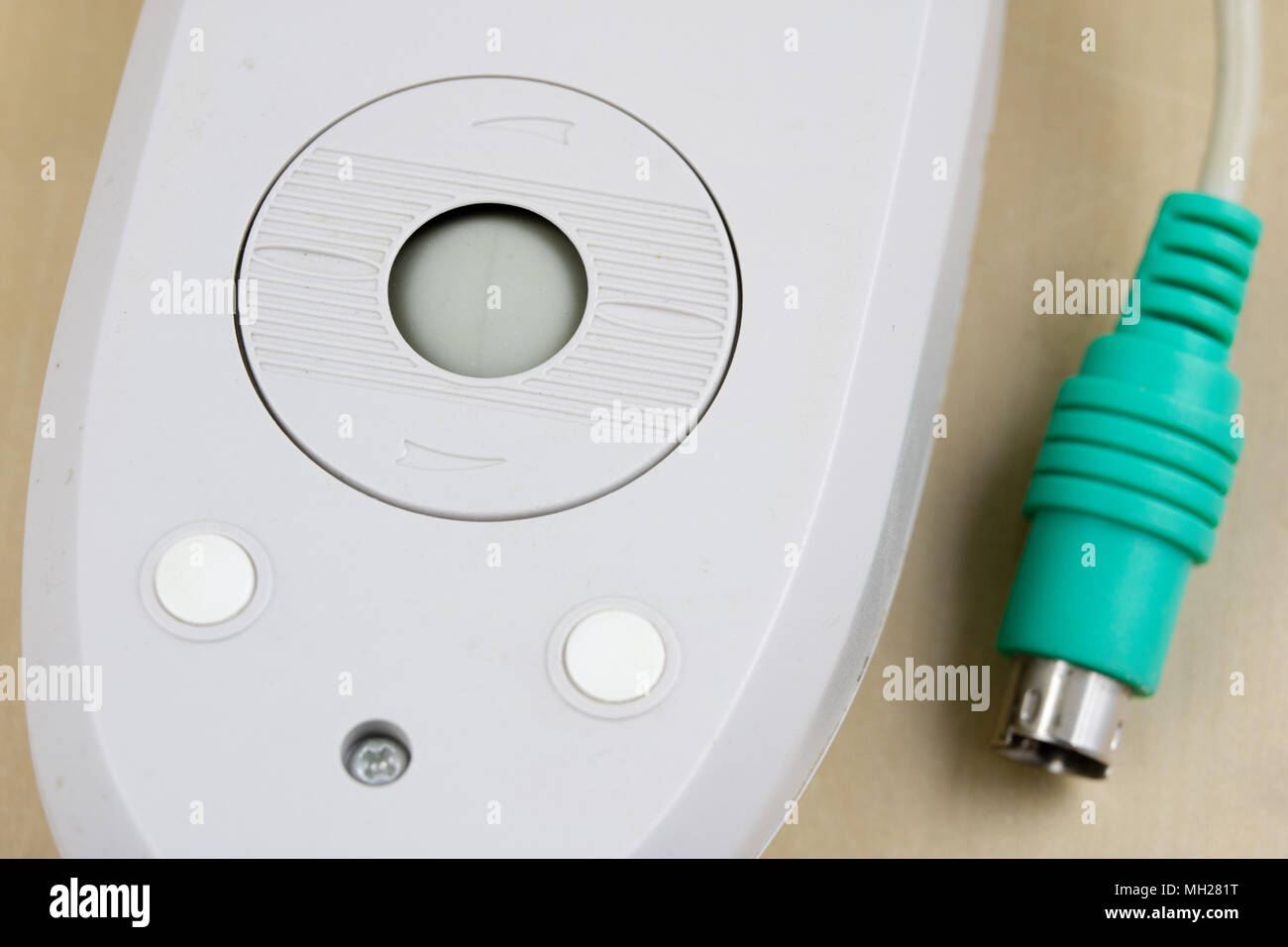 Old computer mouse running on the principle of a ball on a wooden table.  Computer accessories used with computers. Light background Stock Photo -  Alamy