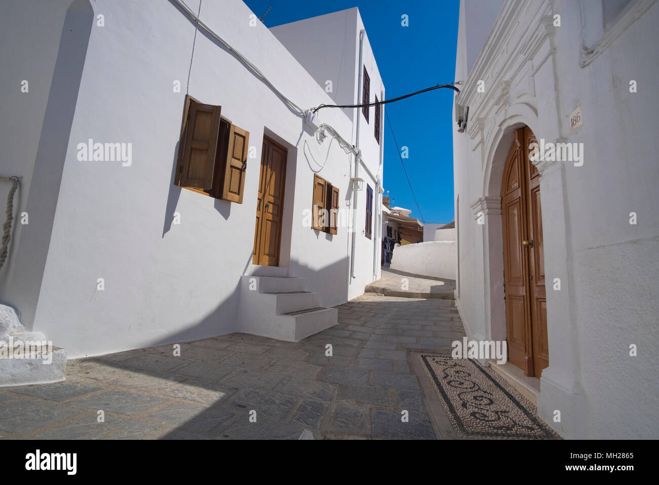 A typical street in Lindos, Rhodes, Greece Stock Photo