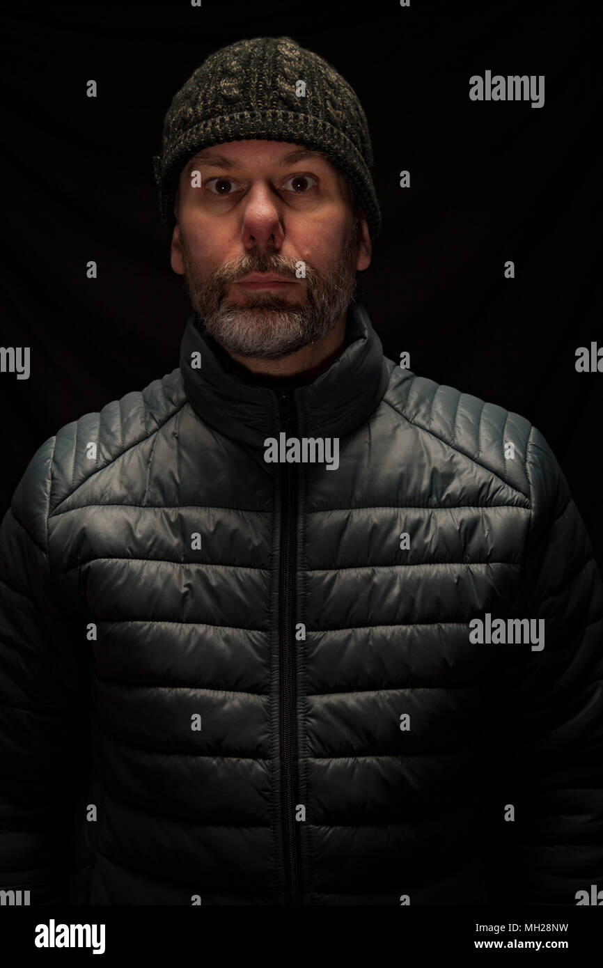 Man wearing puffer jacket and hat Stock Photo Alamy