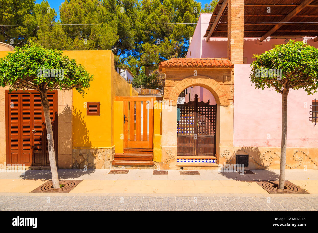 Doorways to typical colorful Spanish houses on street of Sant Elm town, Majorca island, Spain Stock Photo