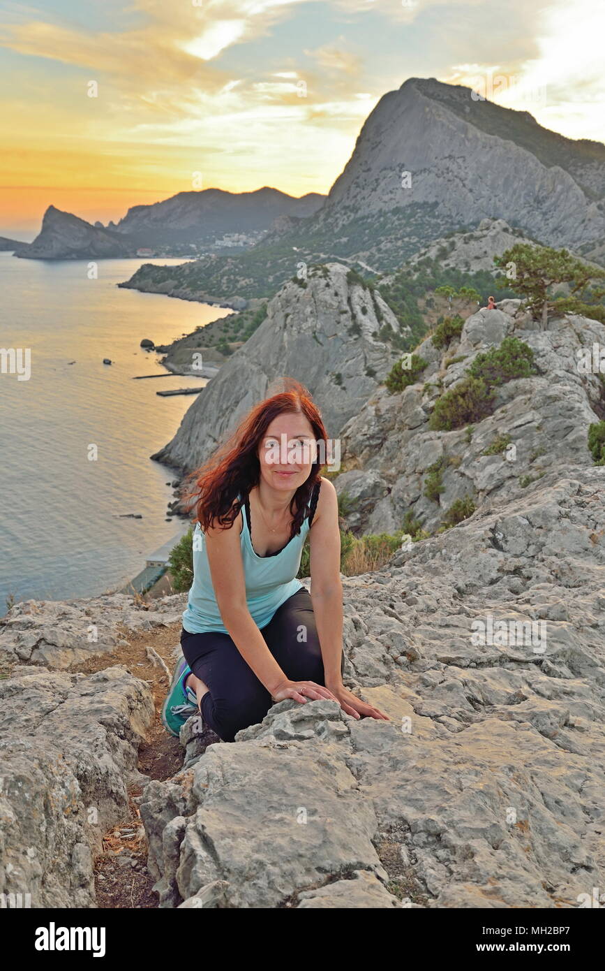 Girl sitting on high hill hi-res stock photography and images - Alamy