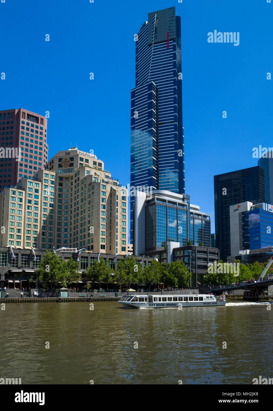 Southbank by the Yarra river in city of Melbourne with the Eurkea Tower towering above office buildings, the Langham Hotel and the Southgate centre Stock Photo