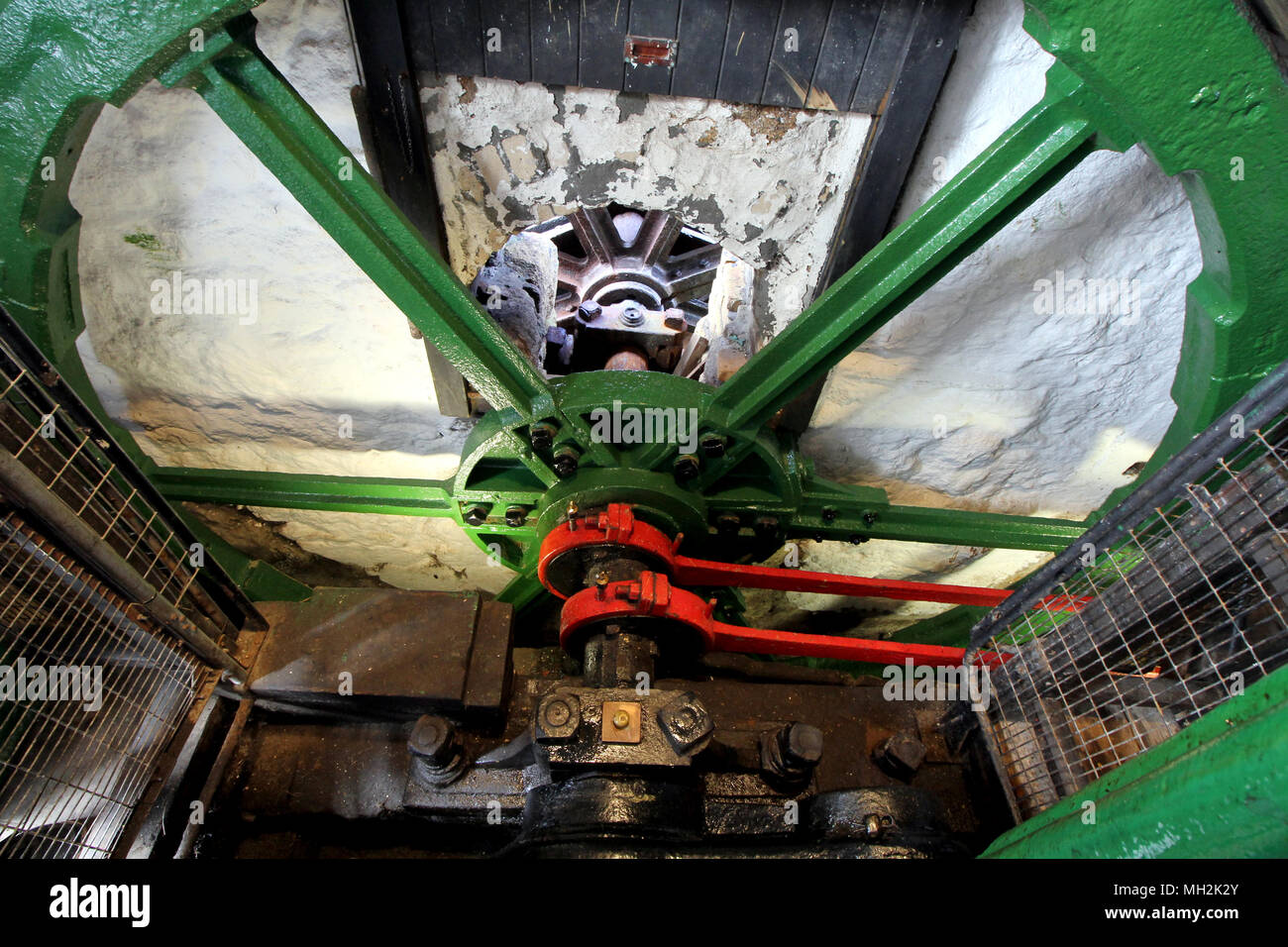 The huge steel flywheel of an industrial steam engine used at a tin
