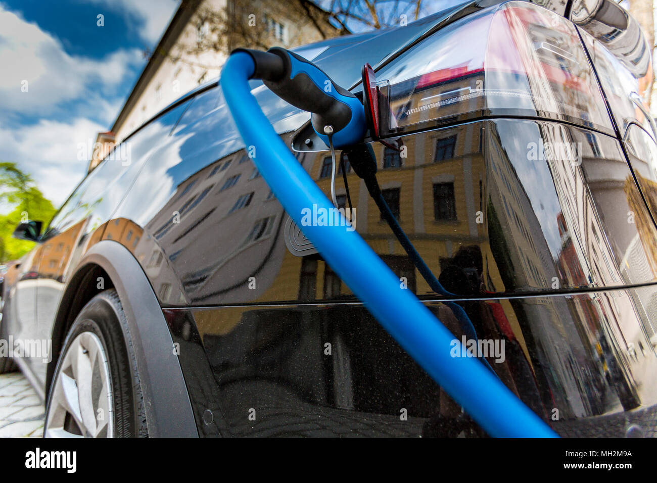 Close up of the power supply plugged into an electric car being charged