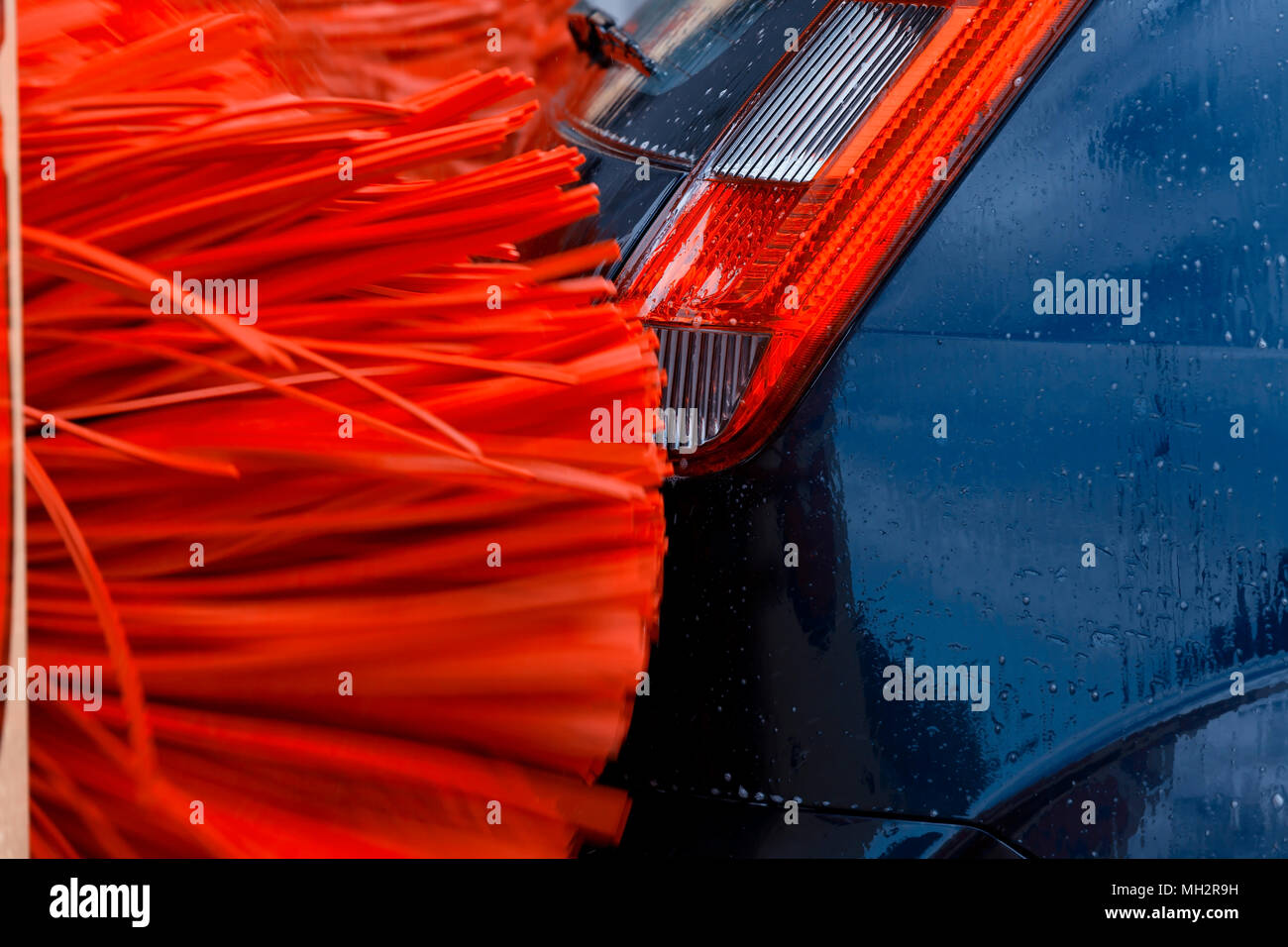 A car inside a car washing machine while it is working Stock Photo Alamy