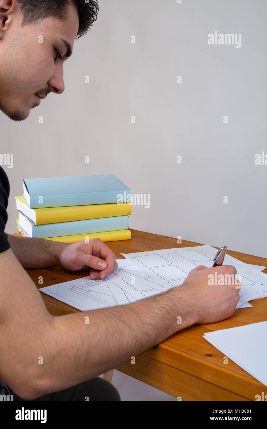 a young man writing, making an argument for a video Stock Photo