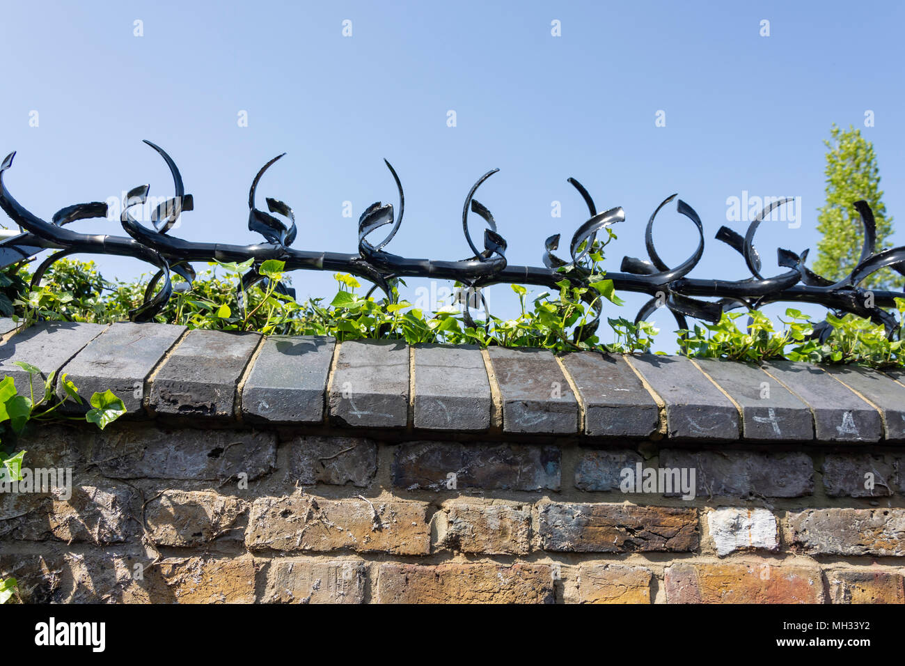Metal security spikes on garden wall, Chiswick, London Borough of Hounslow, Greater London, England, United Kingdom Stock Photo