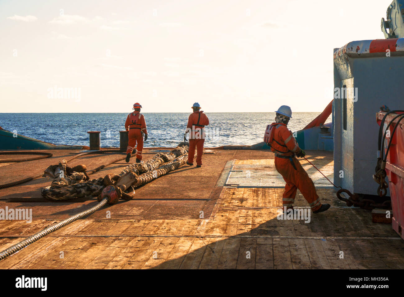 AHTS vessel doing static tow tanker lifting. Ocean tug job Stock Photo