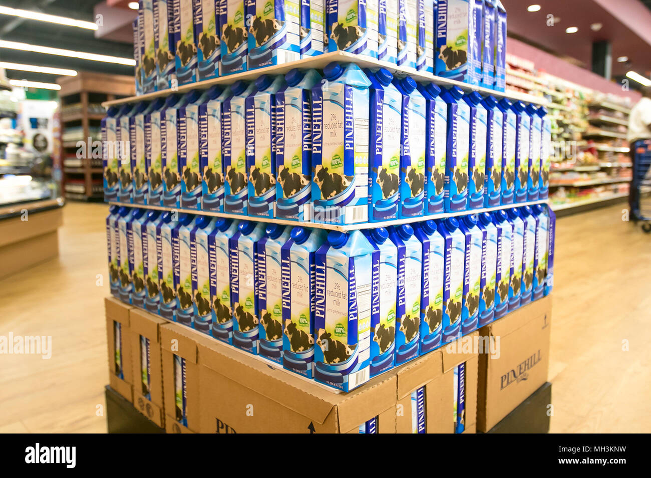 Holetown, Barbados, 03-19-2018: Milk cartons are stacked on the floor of a supermarket. Stock Photo