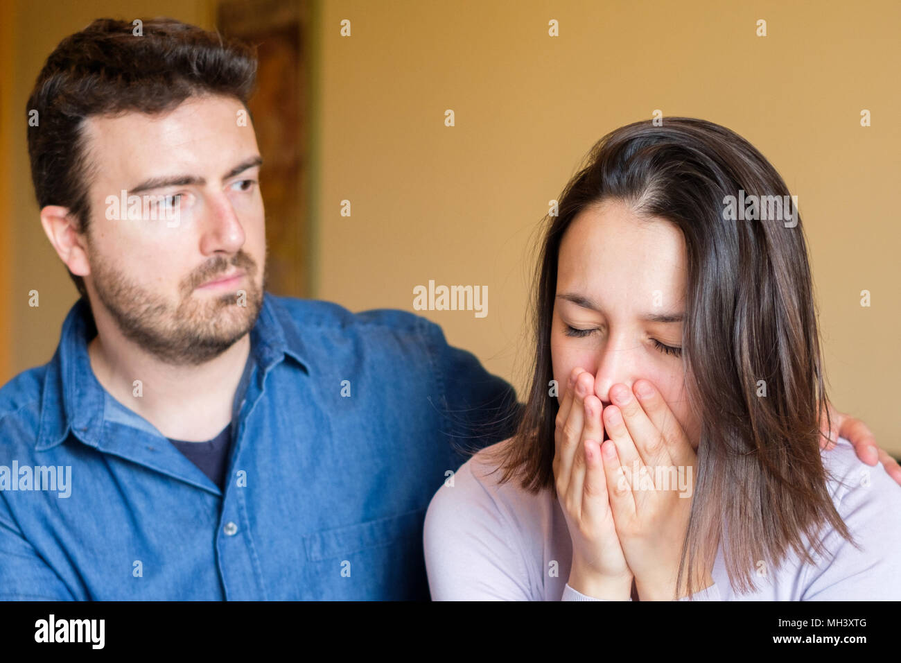 Boyfriend consoling his girlfriend after big fight Stock Photo