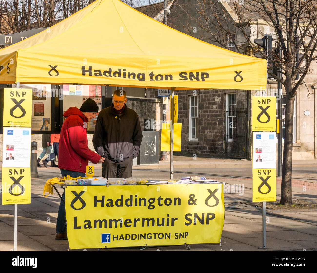 Scottish National Party SNP activists, Haddington branch at street stall, Place d'Aubigny, Court Street, East Lothian, UK on sunny Winter day Stock Photo