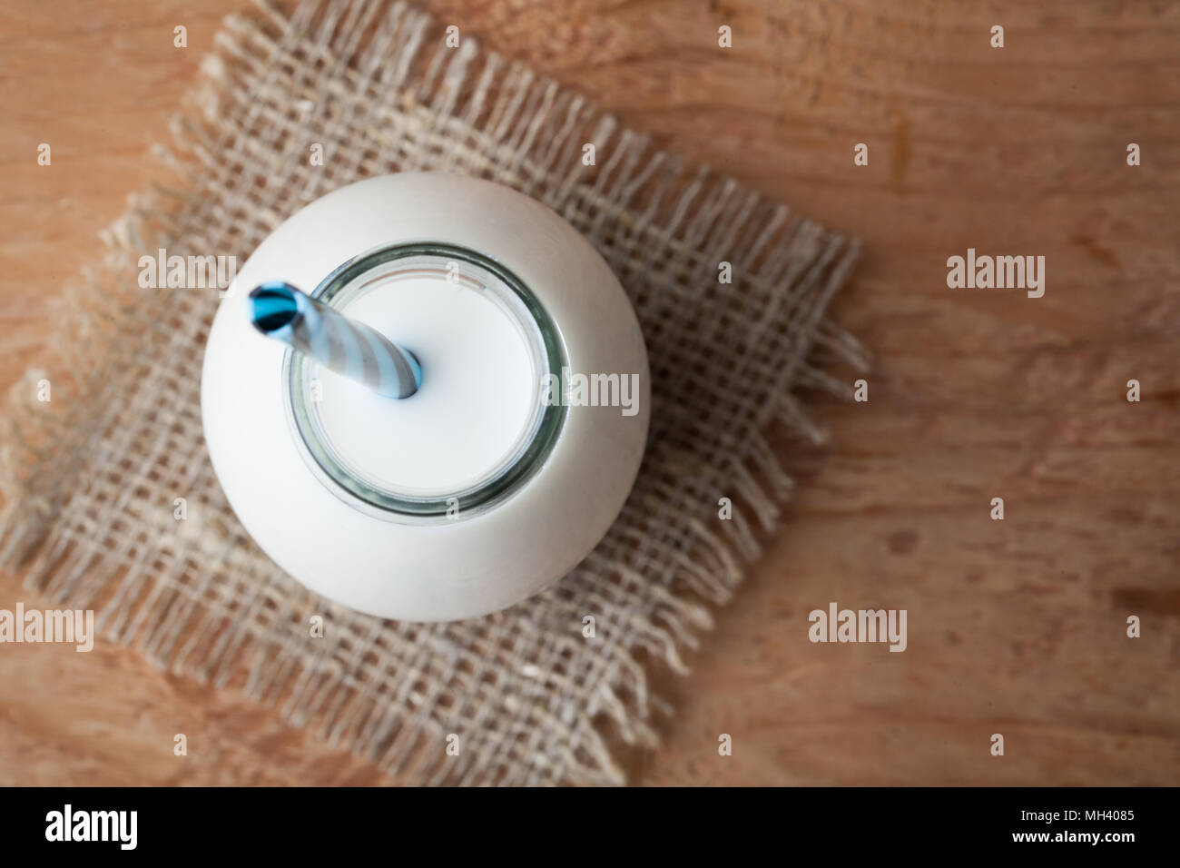 Bottle with milk on dark background with copy space. Top view. Stock Photo