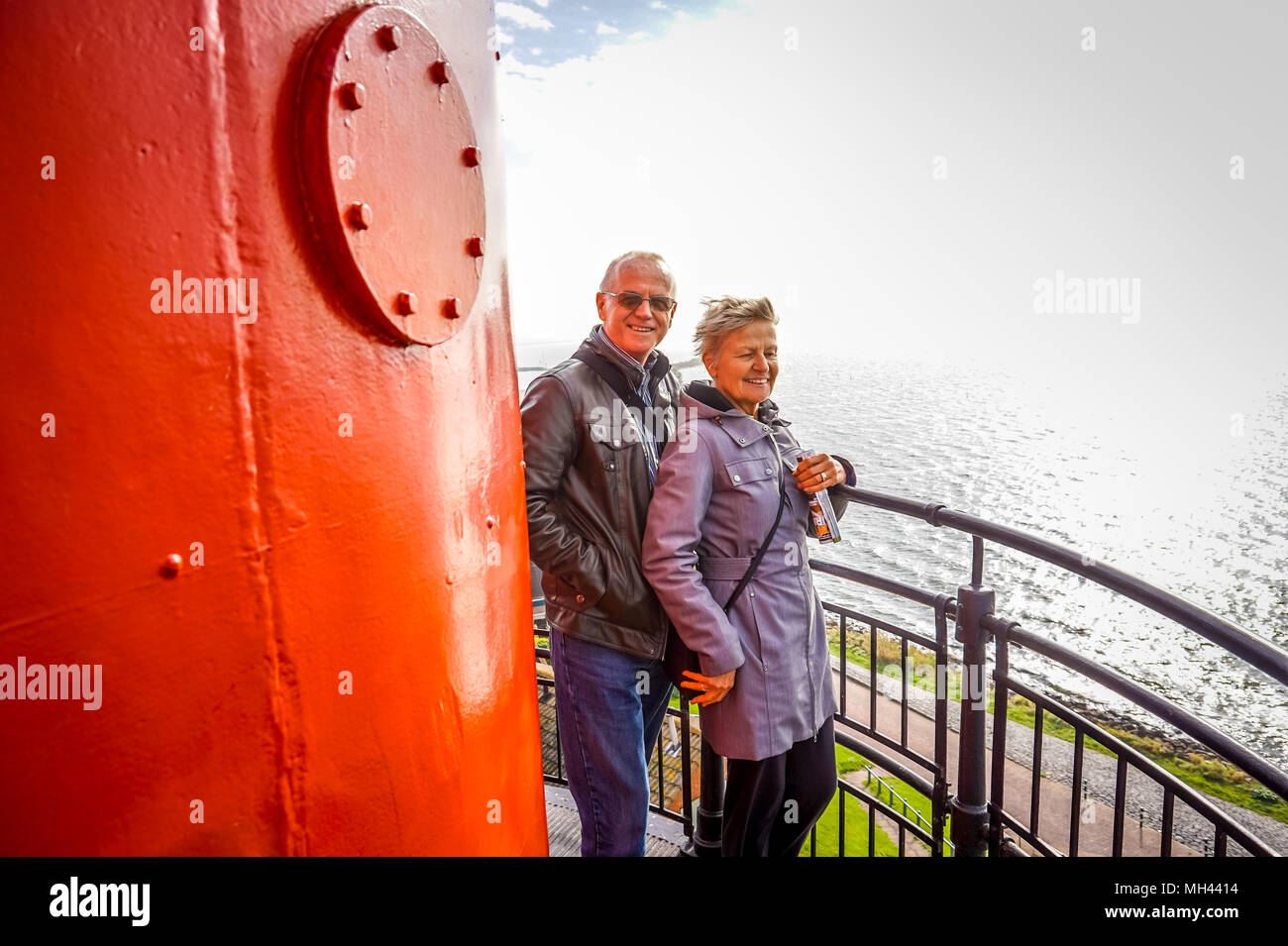 A couple enjoying the view of the Ijsselmeer from the Lighthouse in the fishing village of Urk, the Netherlands Stock Photo