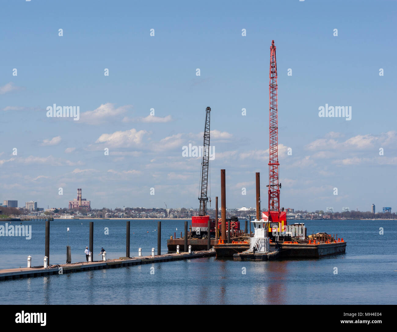 Marine construction barges with cranes for pile driving. Marina Bay, Quincy, MA. Stock Photo