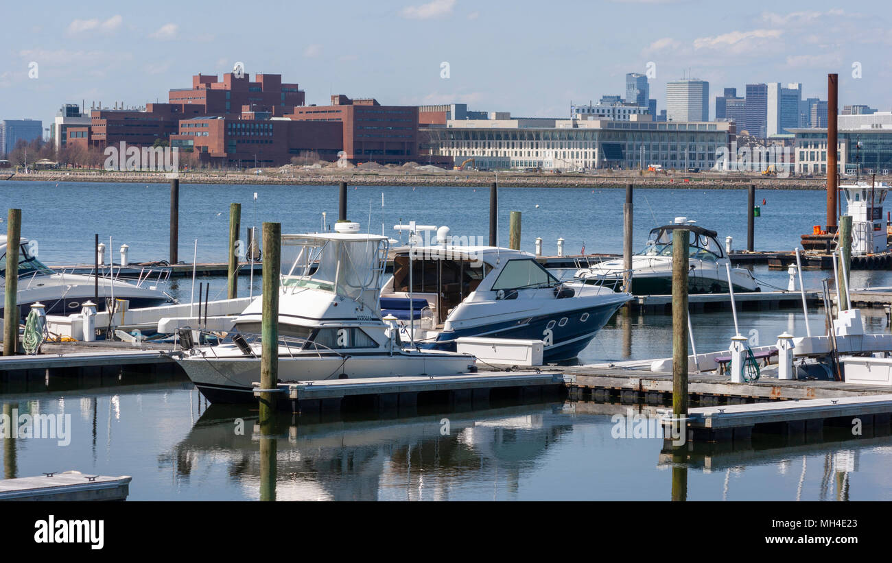 Yachts moored at Marina Bay docks in Quincy, with University of