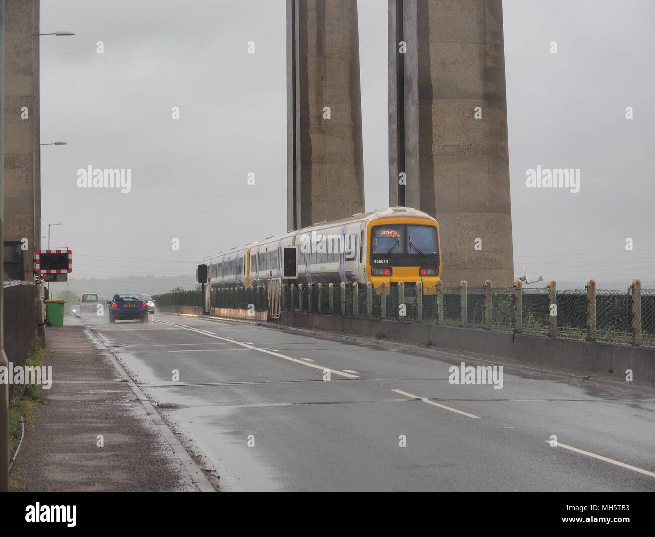 Sheppey Crossing, Isle of Sheppey, Kent, UK. 30th April, 2018. A man's body has been found early this morning, after police were called to an abandoned car on the northbound carriageway of the Sheppey Crossing. Officers arrived at 2.55am. The body was found in the Swale at 4.44am. The death is not being treated as suspicious. (Photos taken 9am this morning in awful weather). A train crossing the Kingsferry Bridge. Credit: James Bell/Alamy Live News Stock Photo