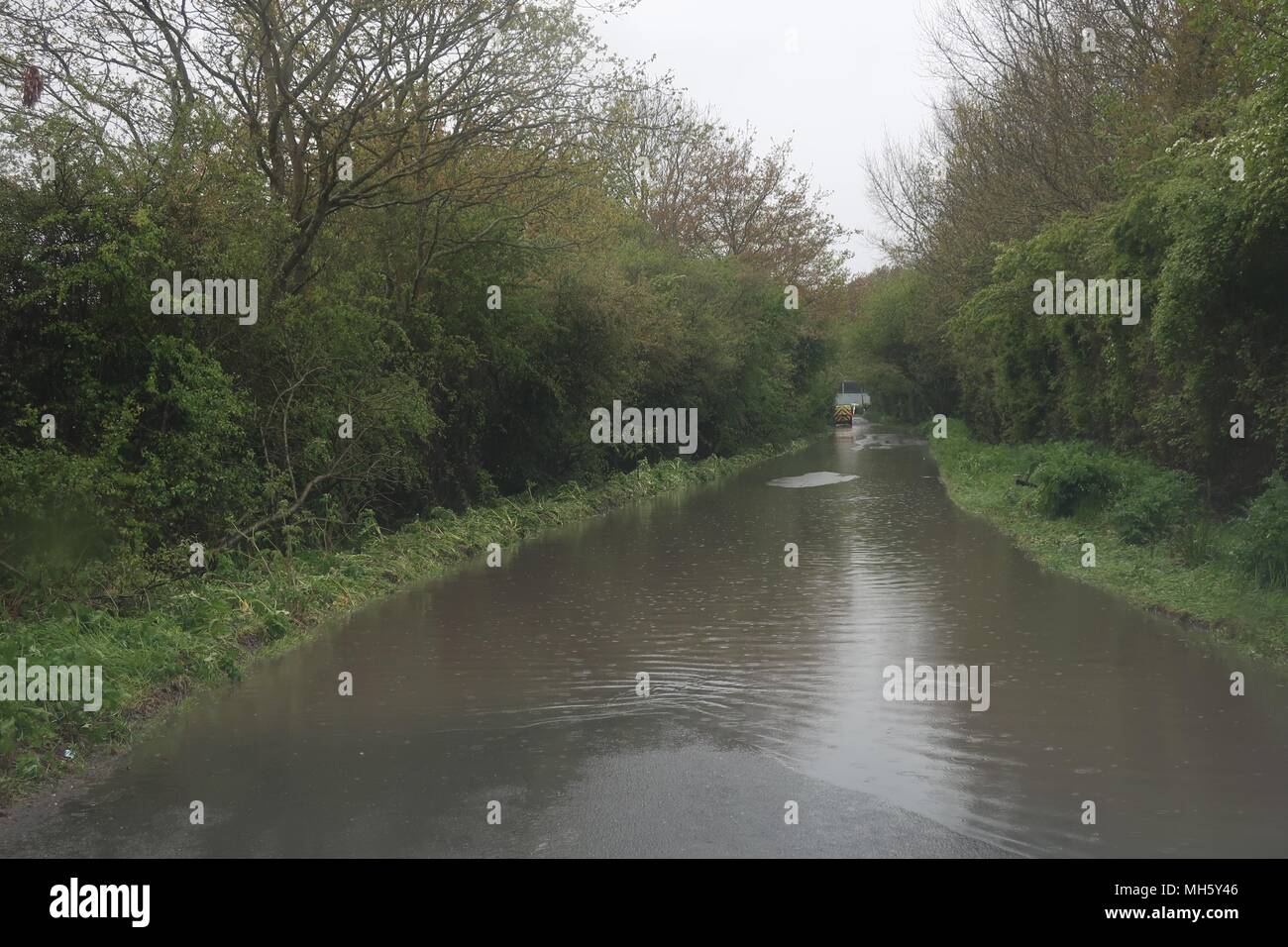 UK weather.A country road in Hailsham flooded after a day of non stop ...