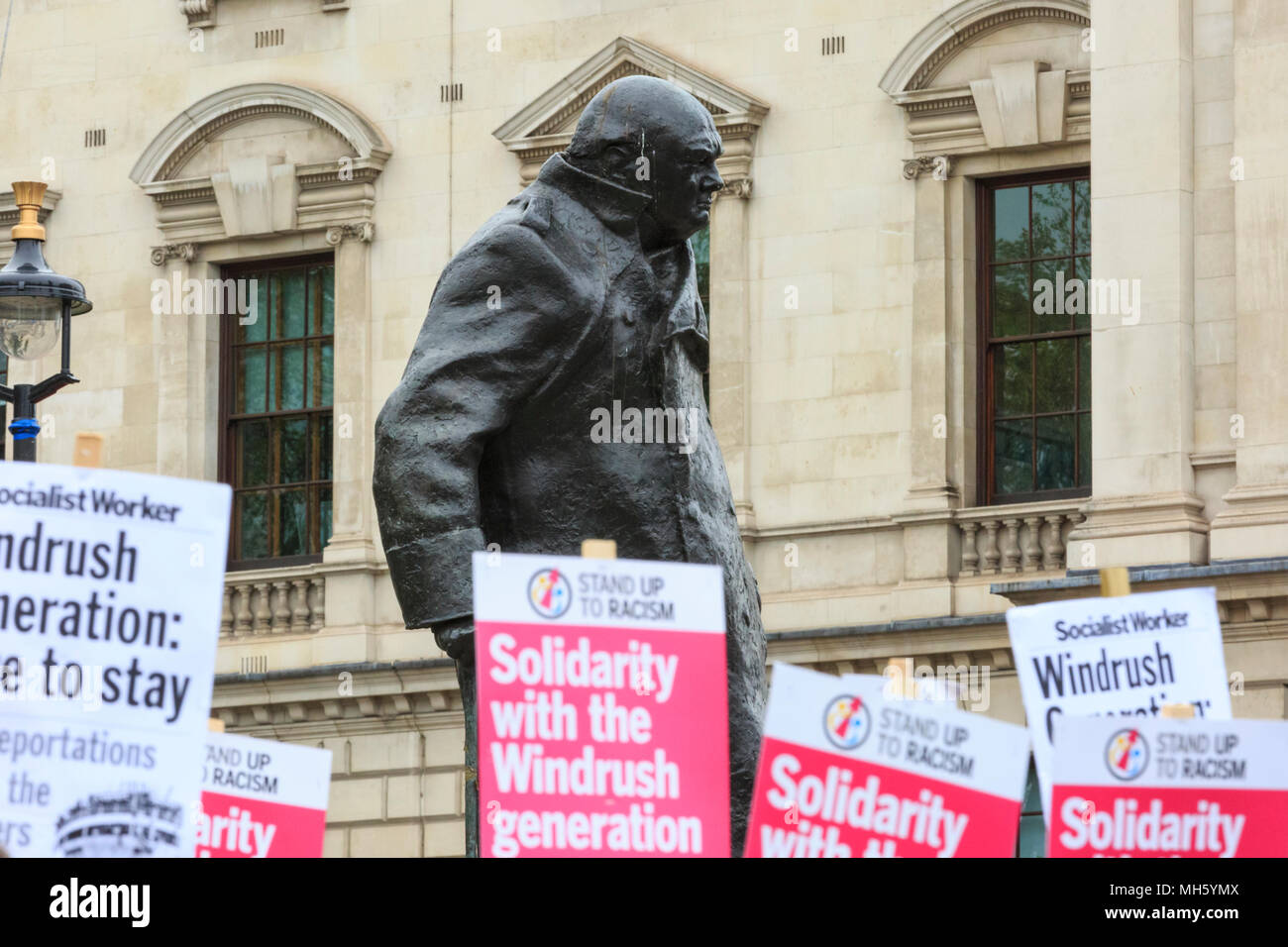 Westminster, London, 30th April 2018. People protest in solidarity, standing in front of the Churchill Statue in Parliament Square. A 'Solidarity with the Windrush generatiion' protest is organised by Stand Up to Racism to signal unity and common anti-racism aims. Credit: Imageplotter News and Sports/Alamy Live News Stock Photo