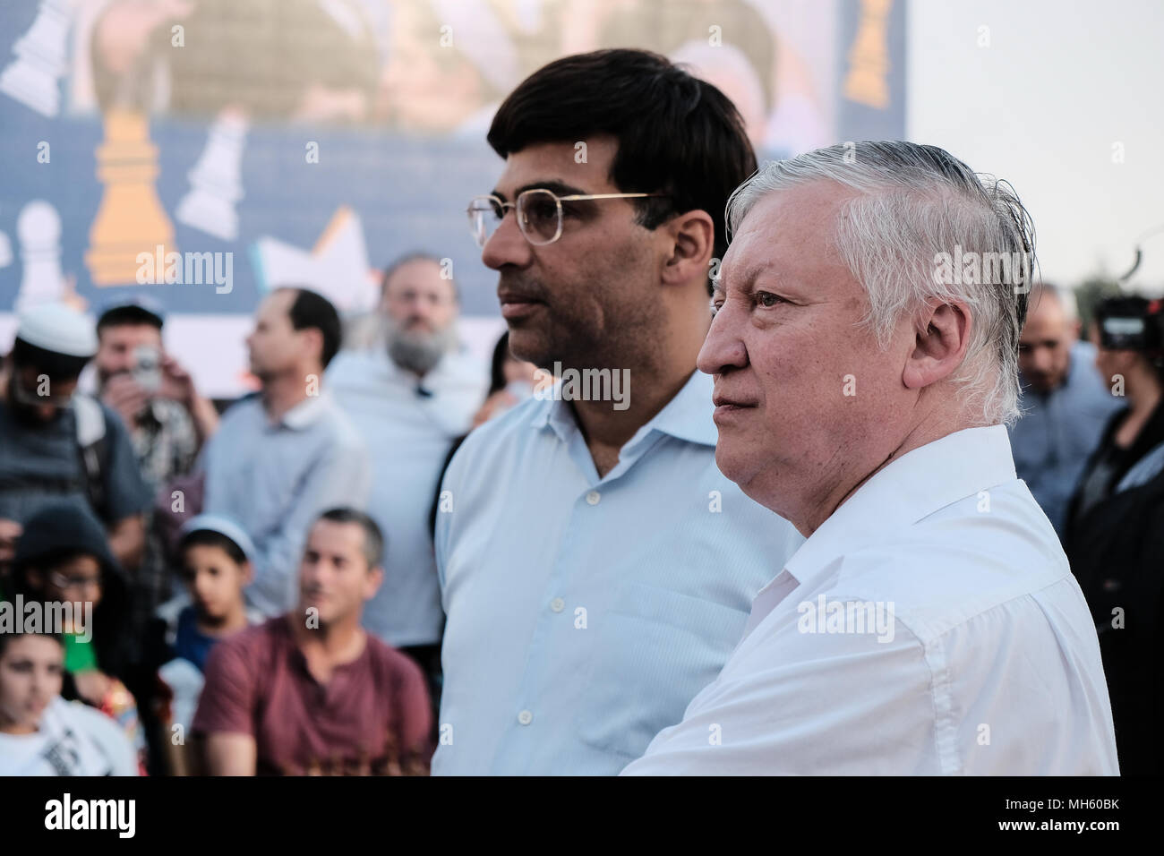 Jerusalem, Israel. 30th April, 2018. ANATOLY YEVGENYEVICH KARPOV (R), 66, Russian chess grandmaster and VISWANATHAN VISHY ANAND (2nd right), 49, Indian chess grandmaster, play chess against dozens of Israeli youth champions simultaneously at the Jaffa Gate in the framework of Israel's 70th Independence Day celebrations. Credit: Nir Alon/Alamy Live News Stock Photo