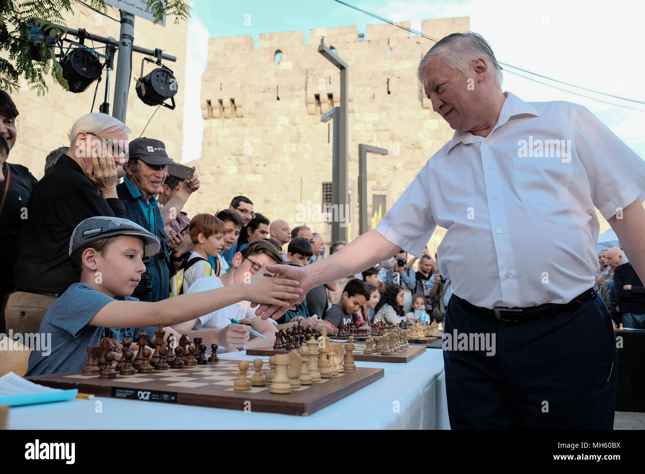 Jerusalem, Israel. 30th April, 2018. ANATOLY YEVGENYEVICH KARPOV (R), 66, Russian chess grandmaster, plays chess against dozens of Israeli youth champions simultaneously at the Jaffa Gate in the framework of Israel's 70th Independence Day celebrations. Credit: Nir Alon/Alamy Live News Stock Photo