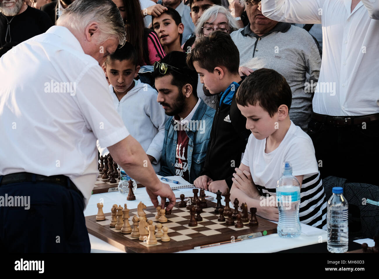 Jerusalem, Israel. 30th April, 2018. ANATOLY YEVGENYEVICH KARPOV (R), 66, Russian chess grandmaster, plays chess against dozens of Israeli youth champions simultaneously at the Jaffa Gate in the framework of Israel's 70th Independence Day celebrations. Credit: Nir Alon/Alamy Live News Stock Photo