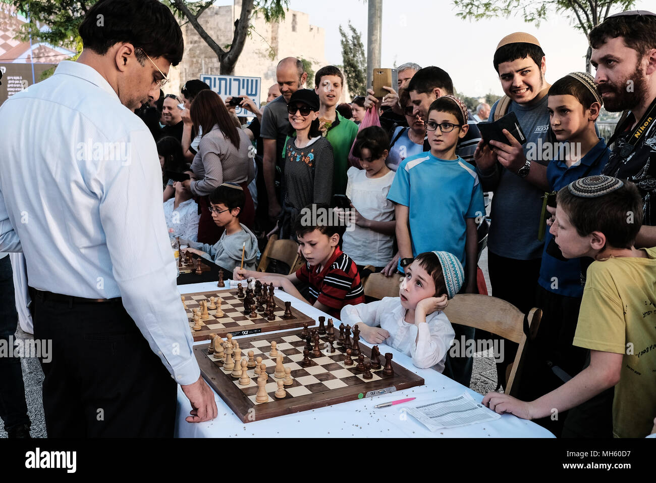 Jerusalem, Israel. 30th April, 2018. VISWANATHAN VISHY ANAND, 49, Indian chess grandmaster, plays chess against dozens of Israeli youth champions simultaneously at the Jaffa Gate in the framework of Israel's 70th Independence Day celebrations. Credit: Nir Alon/Alamy Live News Stock Photo