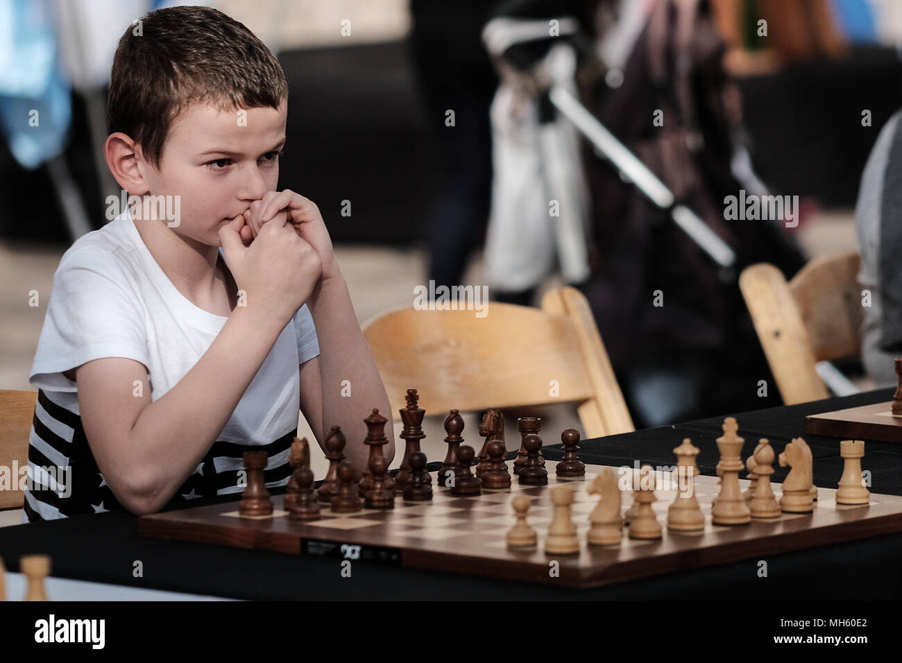 Jerusalem, Israel. 30th April, 2018. Young chess players await the opening of a chess game against either Anatoly Yevgenyevich Karpov, 66, Russian chess grandmaster or Viswanathan 'Vishy' Anand, 49, Indian chess grandmaster, about to play chess against dozens of Israeli youth champions simultaneously at the Jaffa Gate in the framework of Israel's 70th Independence Day celebrations. Credit: Nir Alon/Alamy Live News Stock Photo