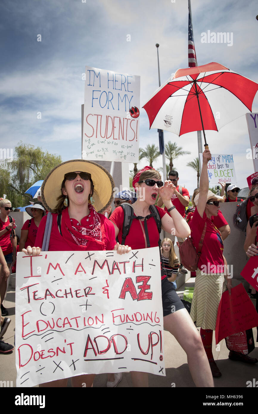 Phoenix, Arizona, USA. 30th Apr, 2018. From right, Arizona teachers from Basis School in Flagstaff, Erin Camish, physics and Alex Gray, math and geography, demonstrate with thousands of their colleagues at the state capitol in Phoenix for a third day. In the largest teacher strike in Arizona history, teachers walked out on Thursday April 26, to demand legislators fix school funding as they work in the state budget. The state ranks 49th in per-pupil spending in the nation. Red for Ed reminds supporters to wear the color to express their support of teachers. (Credit Image: © Rick D'Elia via Stock Photo