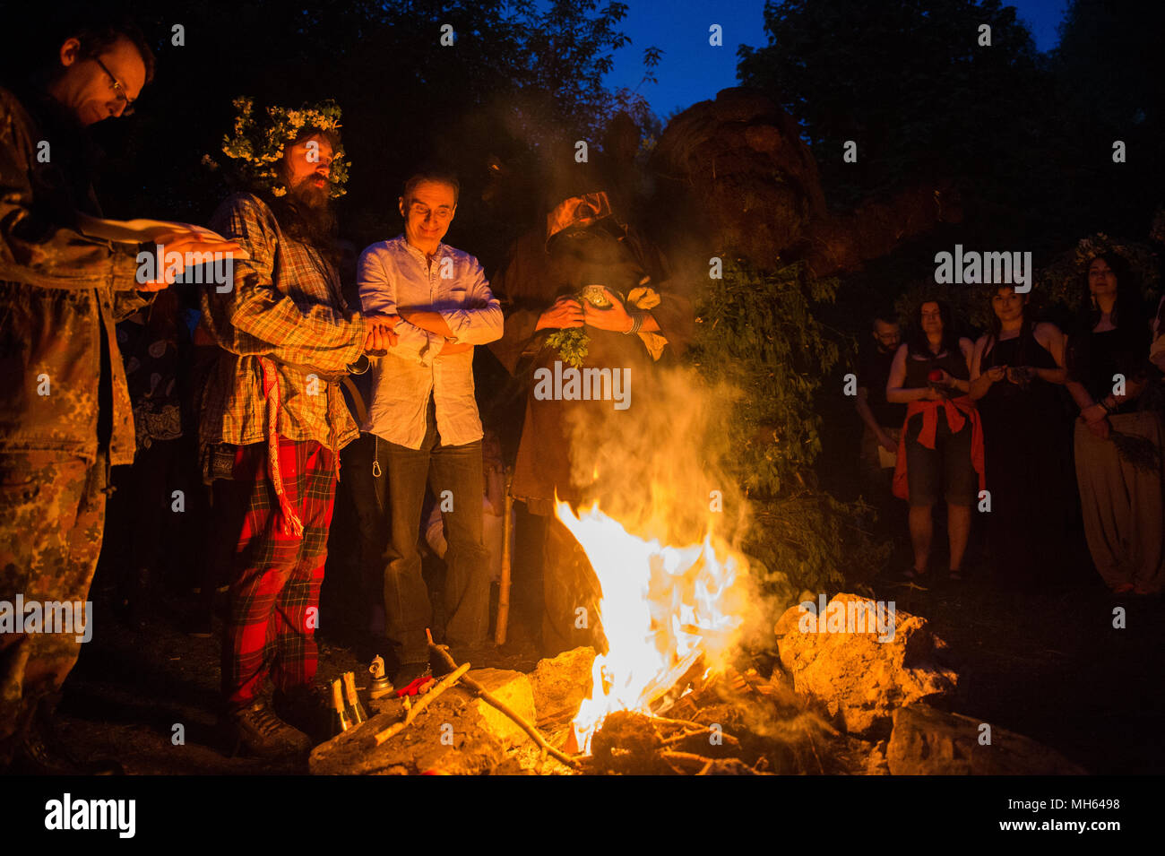 Participants pray during the Beltane feast of Fire next to Krakau Mound in Krakow. The Beltane Fire Festival is an annual participatory arts event held on the night 30 April to mark the beginning of the Summer. Stock Photo