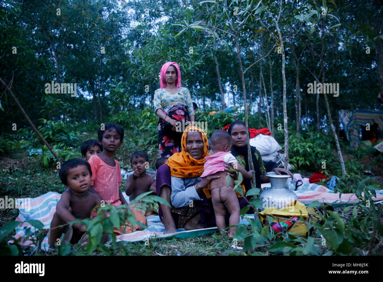 Rohingya refugees take shelter under open sky beside a road at Teknaf