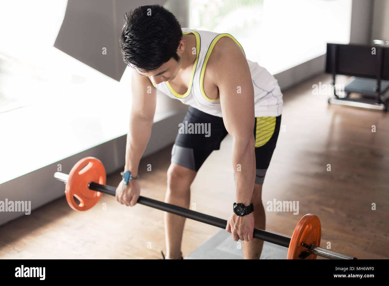 Man exercising bent over rowing with barbell for back muscles Stock Photo Alamy