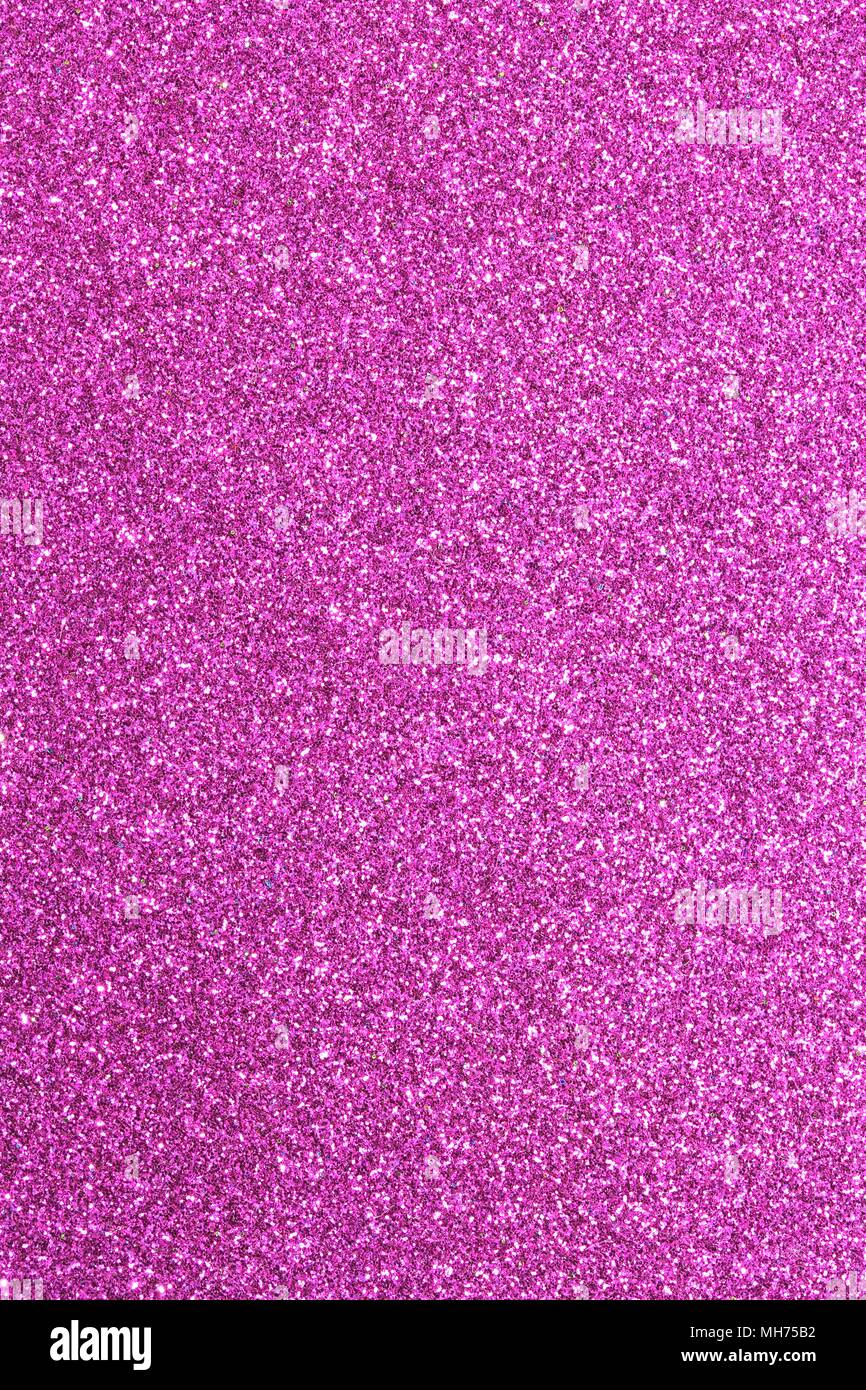 Magenta glitter background in reflective and shimmering material ideal