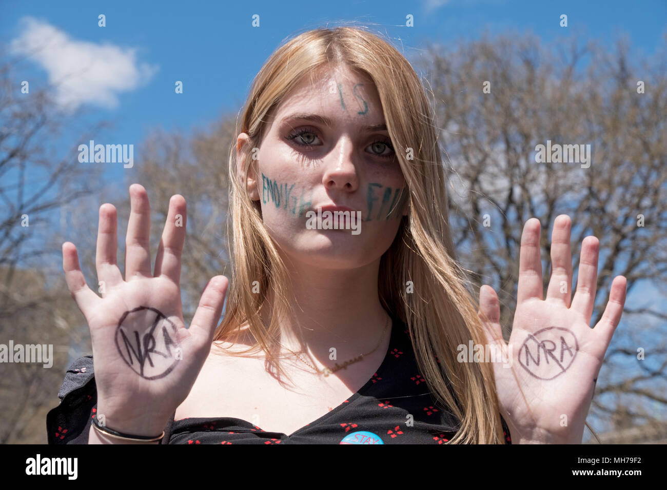 A young girl protesting against the NRA & the ease of buying a gun at the National Schools Walkout rally in Washington Square Park in New York City. Stock Photo