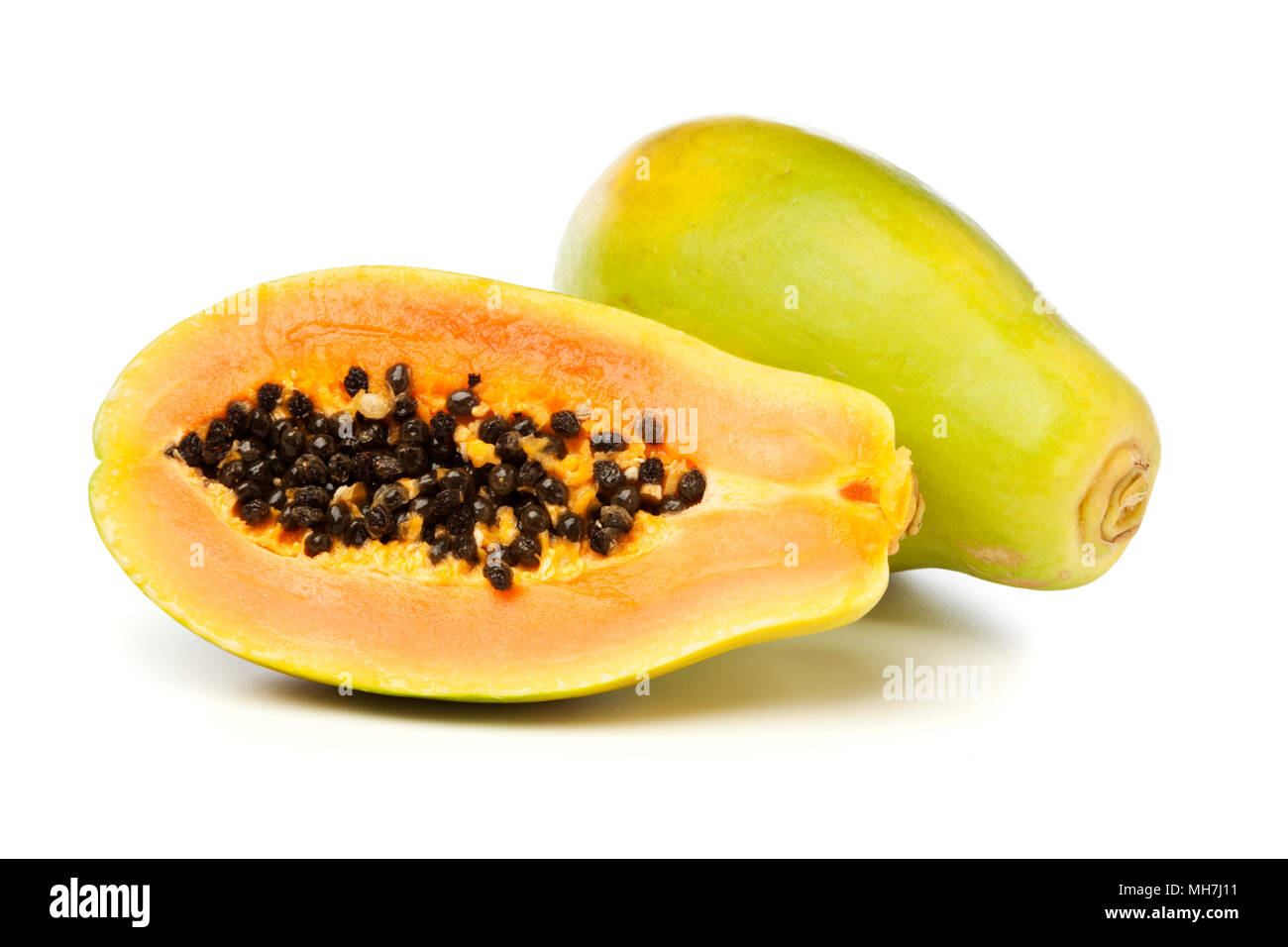 Halved and whole Papayas isolated on white background Stock Photo Alamy